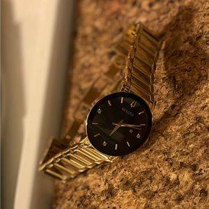 Bulova men’s watch brand new gold band black face with 3 diamonds in the face.